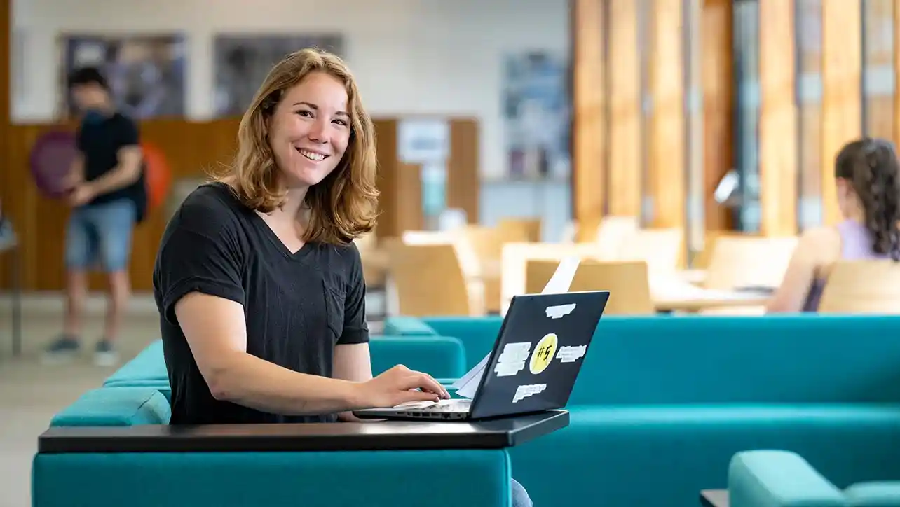 Southampton online student smiling with a laptop