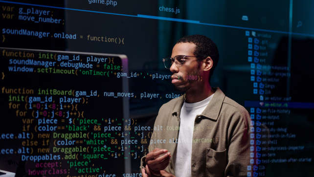 AI professional looking at computer code
